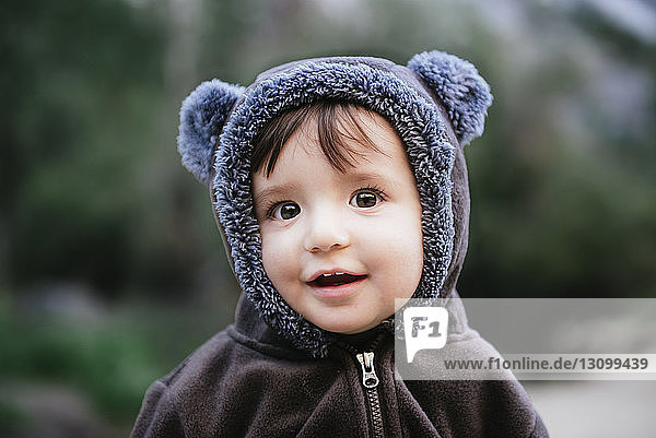 Close-up portrait of cute baby girl in warm clothing standing at Yosemite National Park