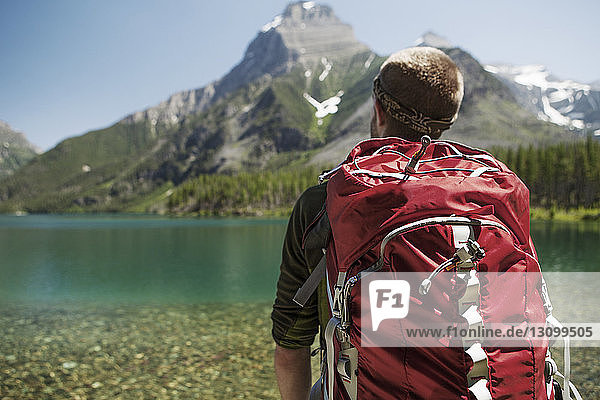 Male hiker carrying backpack at Glacier National Park