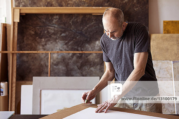 Male artist working in workshop