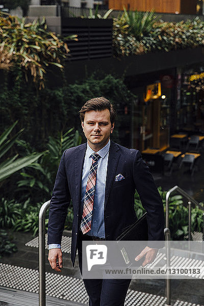 Portrait of confident well-dressed businessman in city