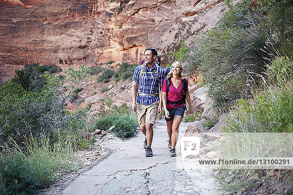 Couple walking on road against mountain
