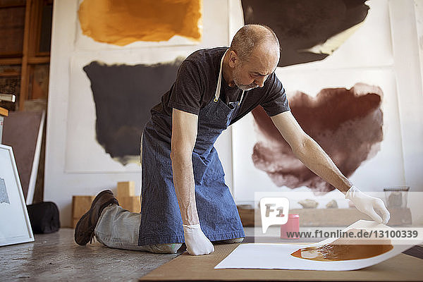 Senior artist making paintings in workshop