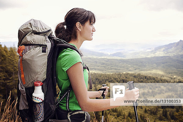 Thoughtful female hiker carrying backpack