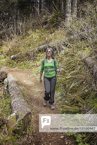 Happy woman hiking in forest