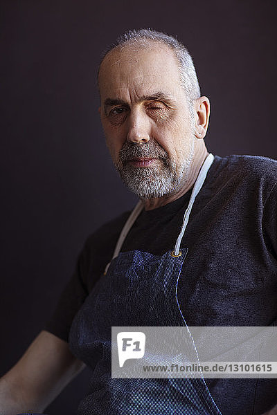 Close-up portrait of senior artist in workshop