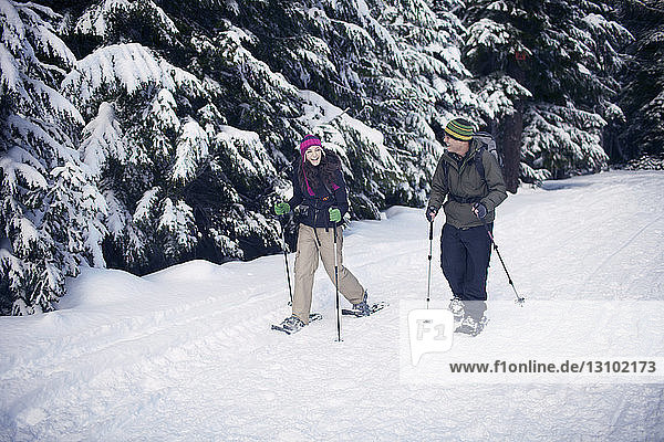 Couple snowshoeing in forest