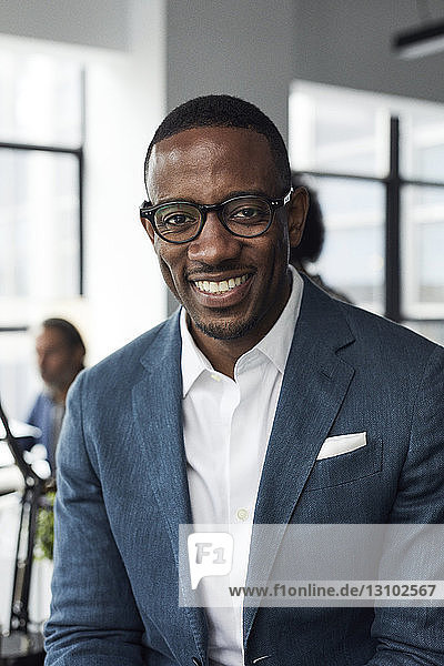 Portrait of happy businessman wearing eyeglasses in office