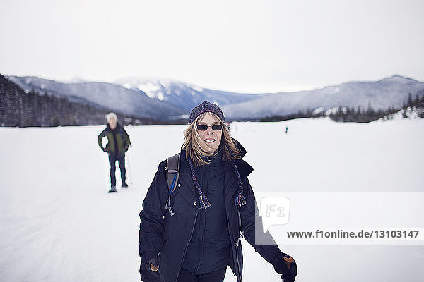 Portrait of woman with her adult son snowshoeing