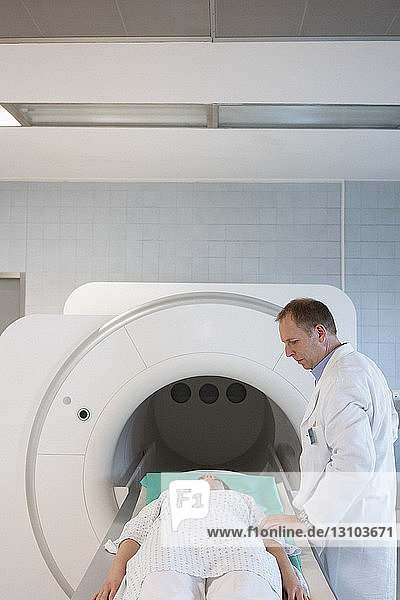 Arzt im Gespräch mit einem Patienten bei der Vorbereitung auf ein MRT im Krankenhaus