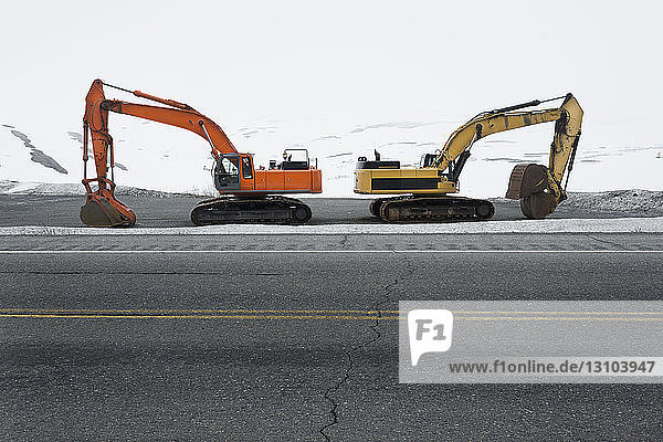 Road clearing excavators parked at roadside along Colony Glacier  Knik Valley  Anchorage  Alaska