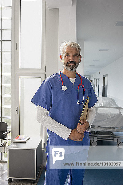 Portrait confident male doctor in hospital corridor