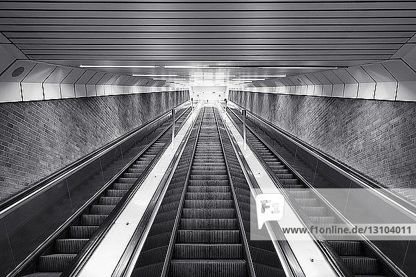 Black and white of ascending escalator
