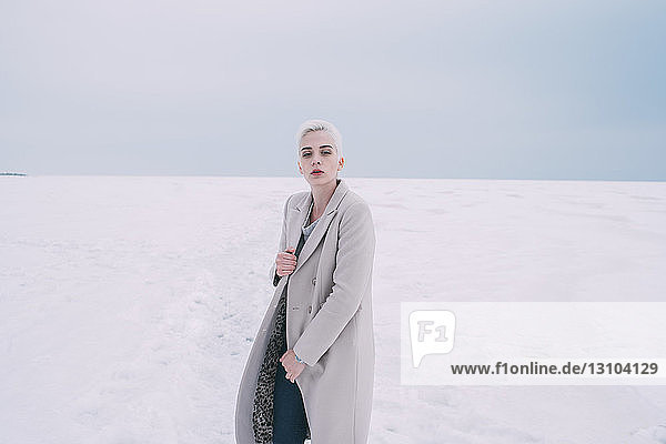 Portrait confident young woman in snowy landscape