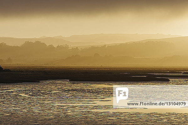 Lifting fog at dawn over the sea in a national seashore reserve area.
