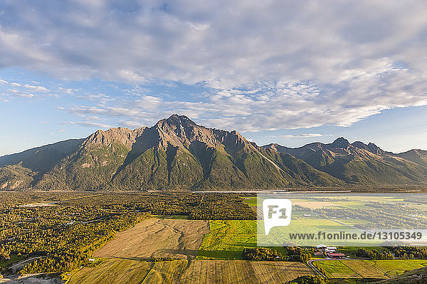 View from the top of the Butte of farmland and Pioneer Peak  and the Knik River in the background  South-central Alaska; Palmer  Alaska  United States of America