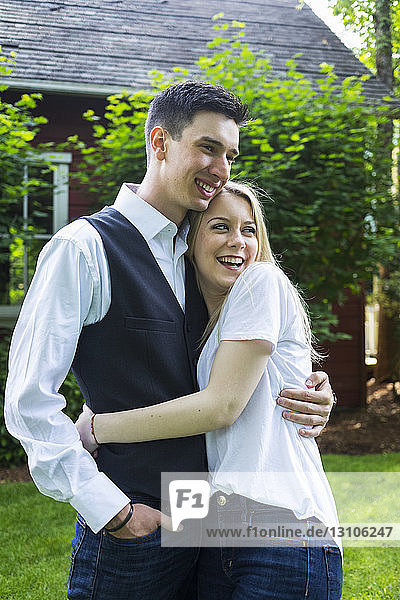Portrait of a young couple standing in a backyard; Bothell  Washington  United States of America