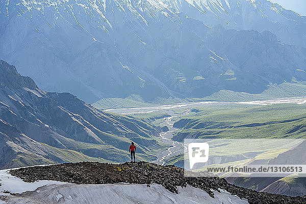 Woman exploring the rugged mountains of Kluane National Park and Reserve; Haines Junction  Yukon  Canada
