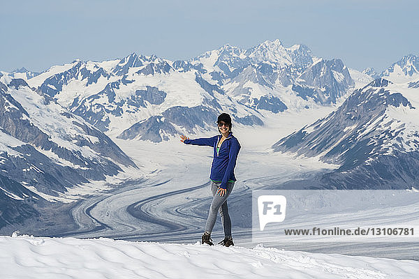 Woman enjoying an afternoon amongst the mountains and glaciers of Kluane National Park and Reserve; Haines Junction  Yukon  Canada