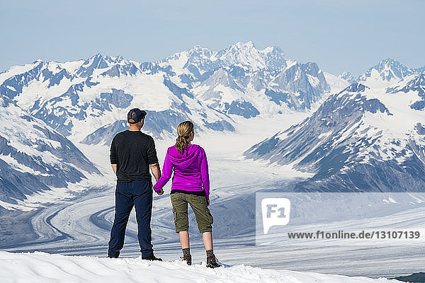 A couple enjoy the sights and scenery of Kluane National Park and Reserve on a bright sunny day; Haines Junction  Yukon  Canada