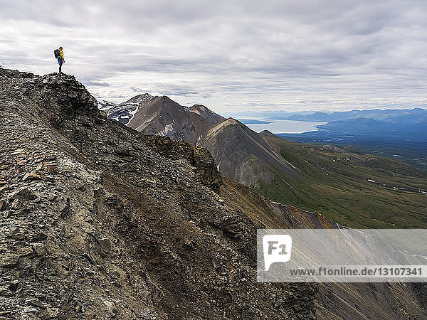 Woman exploring the rugged mountains of Kluane National Park and Reserve; Haines Junction  Yukon  Canada