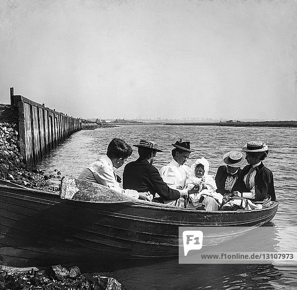 Magic lantern slide circa 1900.Victorian/Edwardian.Social History. A family day out on a rowing boat around 1900. Baby child mother father and relatives