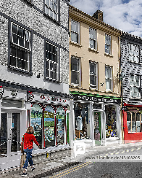 Female tourist shopping in an Irish town; Kinsdale  County Cork  Ireland