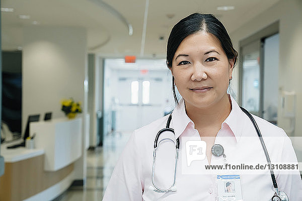 Portrait of confident female doctor with stethoscope in hospital lobby