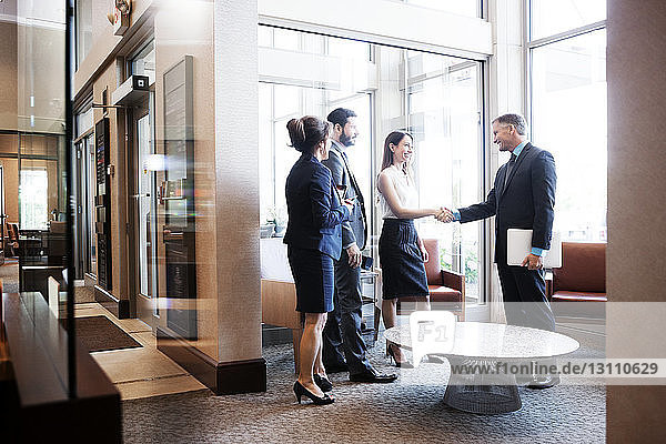 Business people shaking hands at office lobby