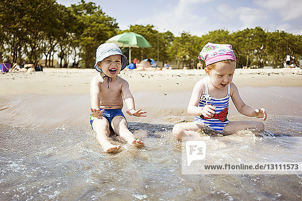 Children playing in water at beach