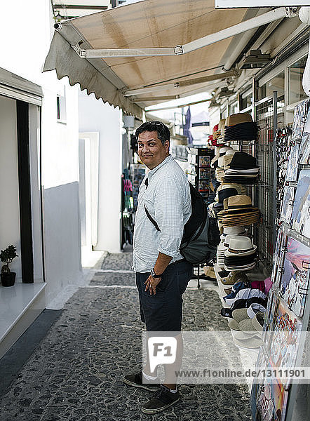 Seitenansicht Porträt eines Touristen  der auf einem Fußweg auf einem Markt in der Stadt steht