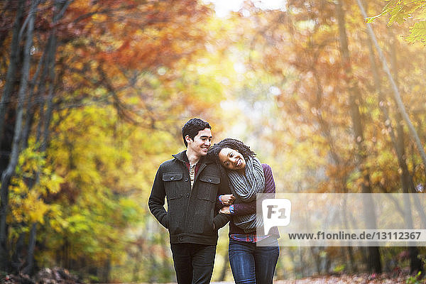 Happy couple walking in forest