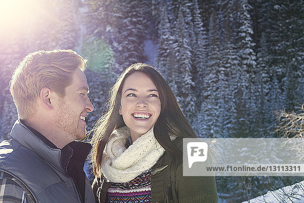Happy couple in forest during winter