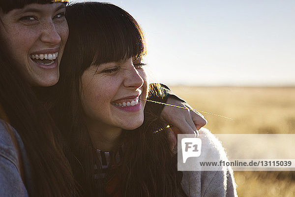 Cheerful female friends enjoying at field