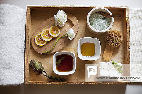 Overhead view of spa products in wooden tray