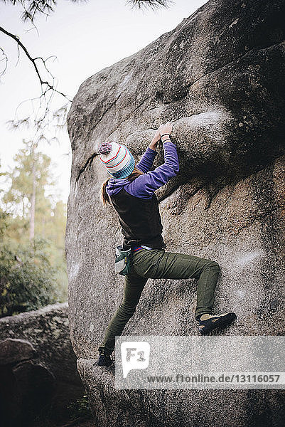 Full length of woman rock climbing