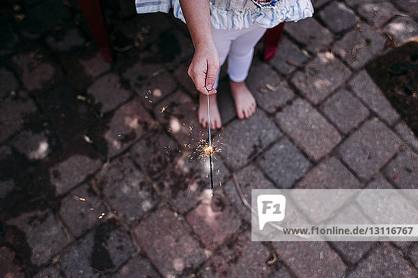 High angle view of girl holding sparkler