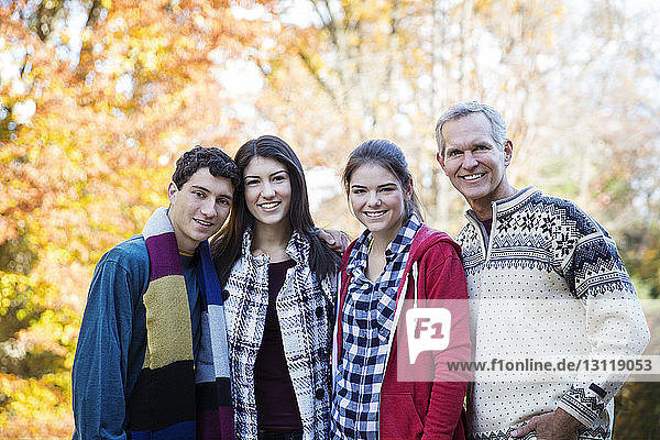 Portrait of happy family standing in forest