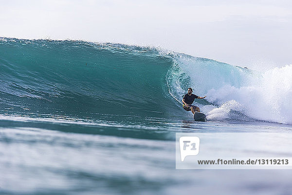Man surfing on sea against clear sky