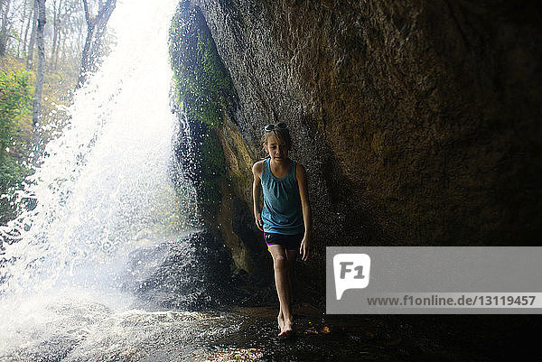 Full length of girl walking by waterfalls