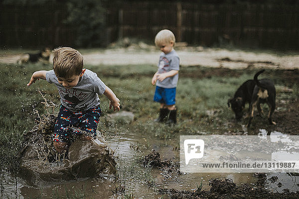 Children playing on muddy field