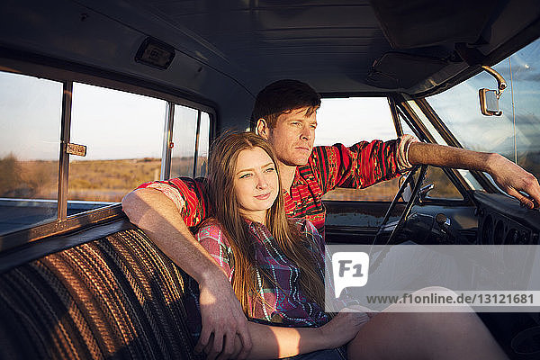 Thoughtful couple sitting in pick-up truck