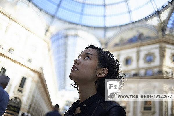 Close-up of woman looking away while standing in Galleria Vittorio Emanuele II