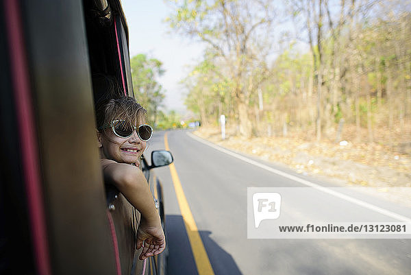 Girl leaning on vehicle window