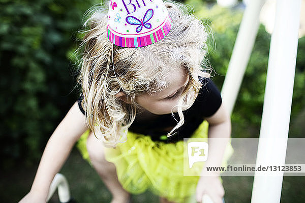 High angle view of girl wearing party hat while playing at playground