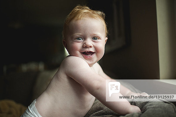 Portrait of cheerful baby boy at home