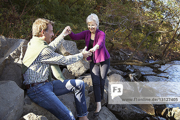 Couple on rocks at lakeshore