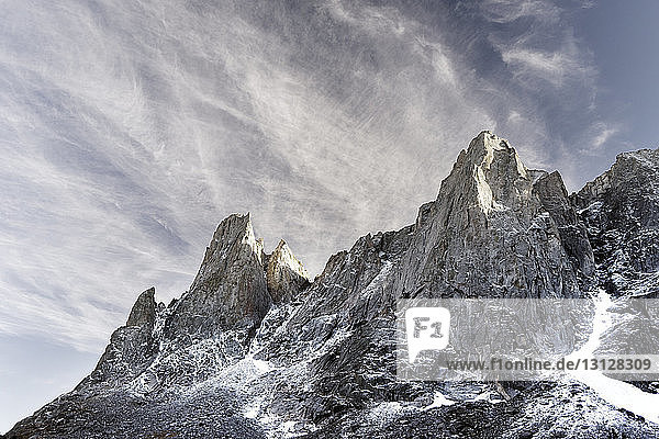Low angle view of mountain against sky during winter