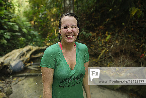 Close-up of happy woman standing in river