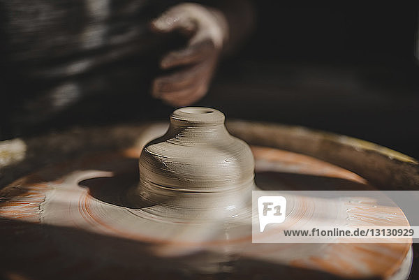 Close-up of clay on pottery wheel at workshop