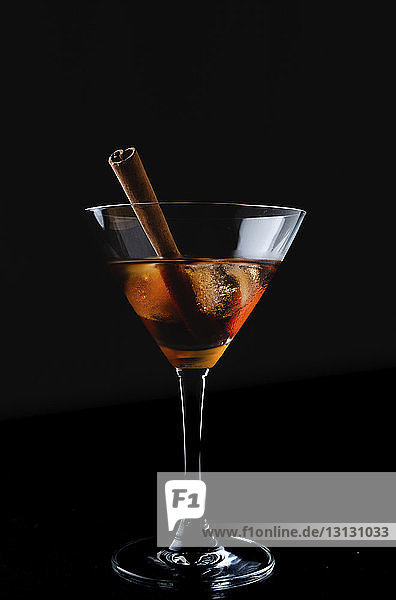 Nahaufnahme eines Getränks im Martini-Glas vor schwarzem Hintergrund